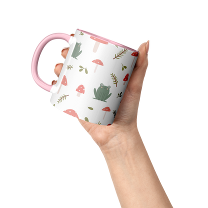 11oz_mug_Mushrooms_and_Frogs_Fairecom_Lifestyle_Raised_Hand_Mockup.png